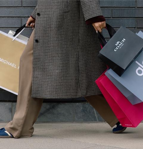 Shopper carrying multiple bags showcasing exclusive offers and retail variety at the shopping centre