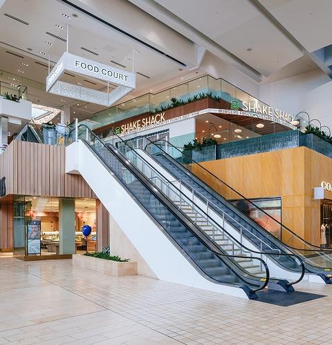 Yorkdale food court area with Shake Shack restaurant and escalator to upper level