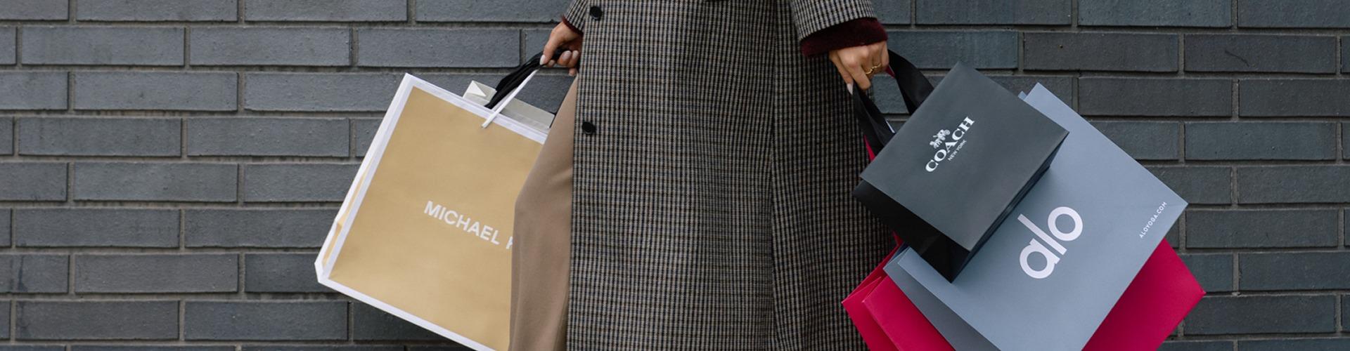 Shopper carrying multiple bags showcasing exclusive offers and retail variety at the shopping centre