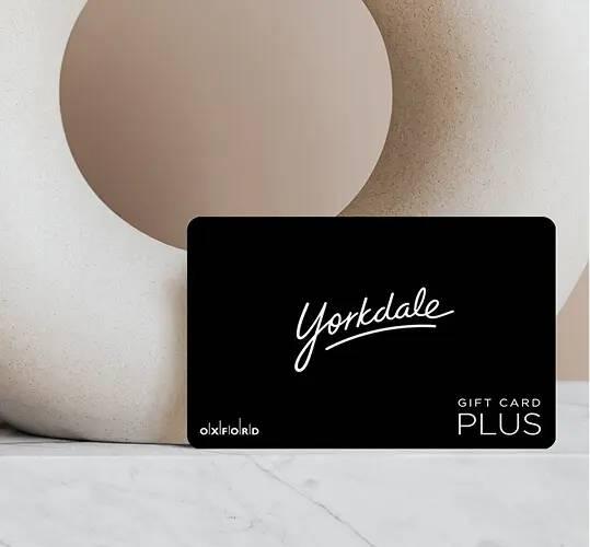 Yorkdale Gift Card Plus on a marble surface with beige sculptural backdrop