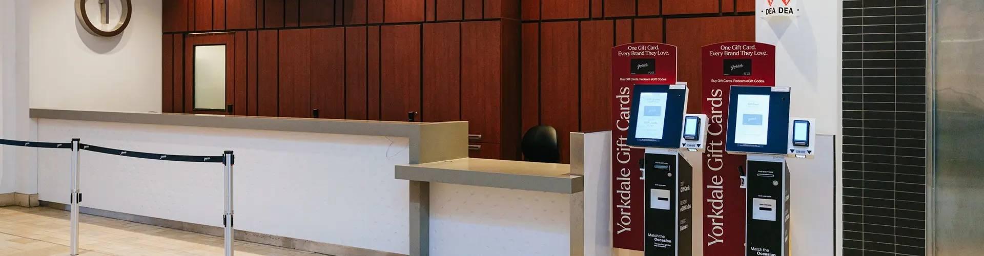 Yorkdale Guest Services counter with two self-serve gift card kiosks
