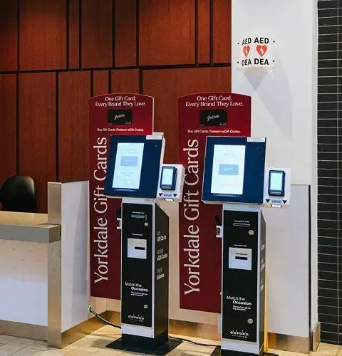 Yorkdale Guest Services counter with two self-serve gift card kiosks