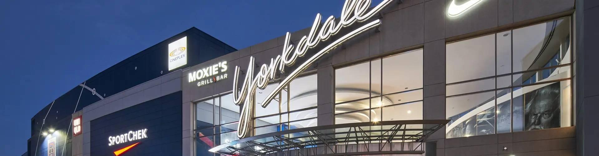 Yorkdale mall exterior at night showing Moxie's, SportChek, Cineplex, and Nike signs