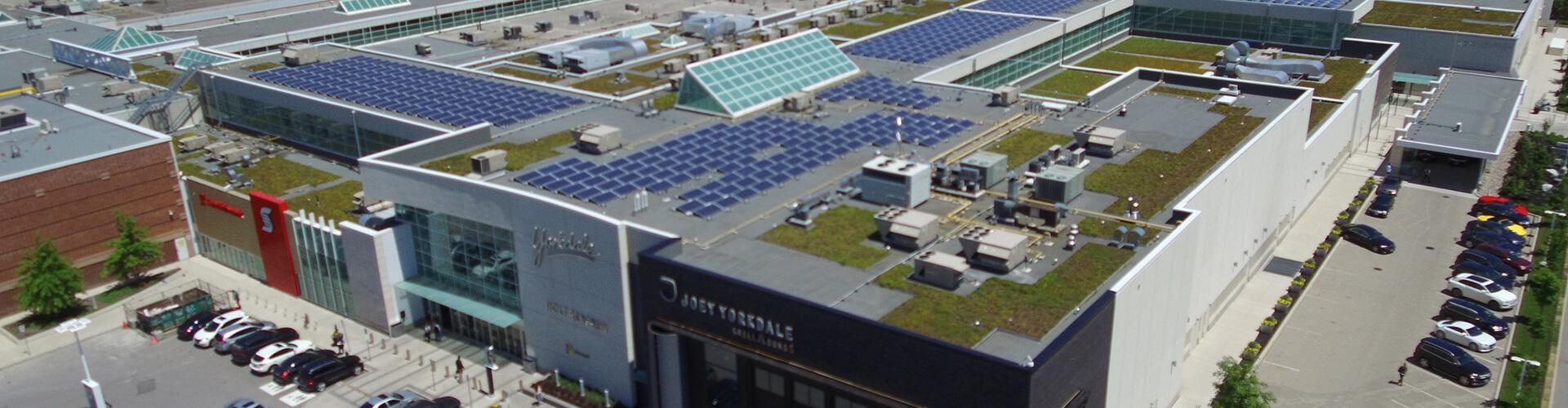 Aerial view of Yorkdale rooftop with solar panels and green roof beside Joey Yorkdale