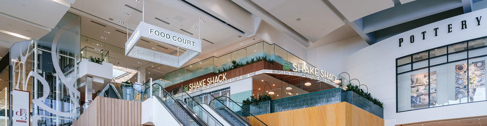 Yorkdale food court area with Shake Shack restaurant and escalator to upper level