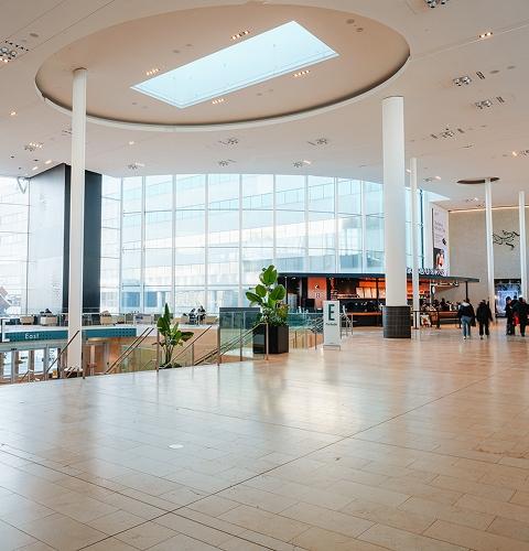 Plan your visit to a bright Yorkdale shopping mall with stores, seating areas and upper-level walkways