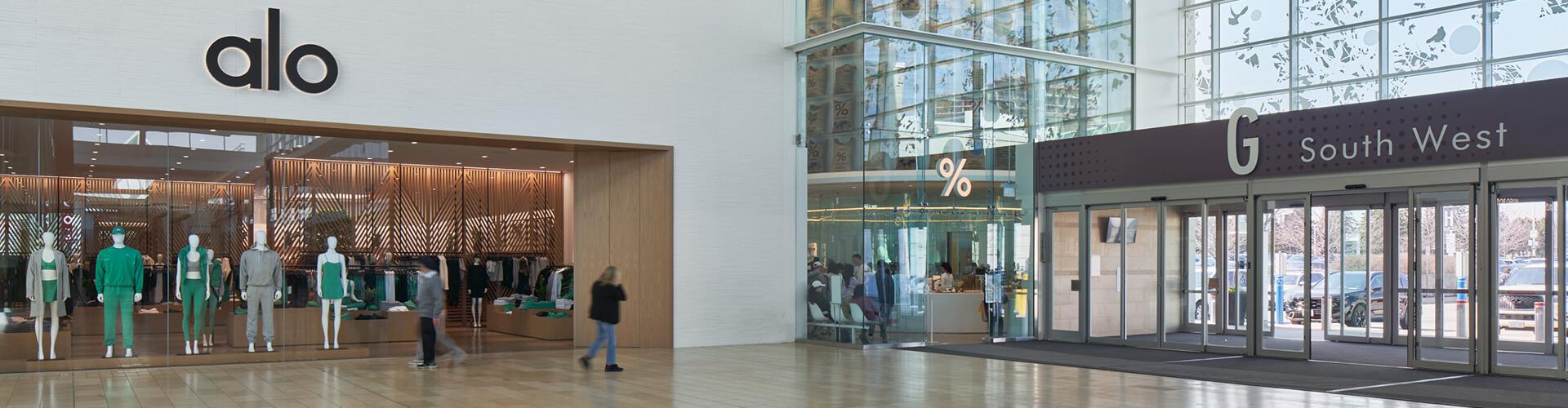 Alo Yoga storefront with mannequins in activewear near the South West entrance