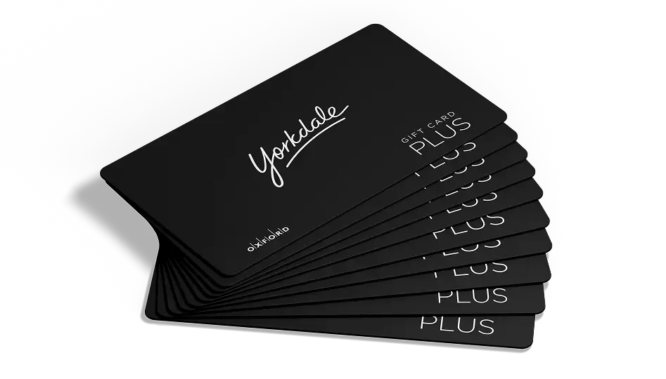 Fan of black Yorkdale Gift Card Plus cards on a white background