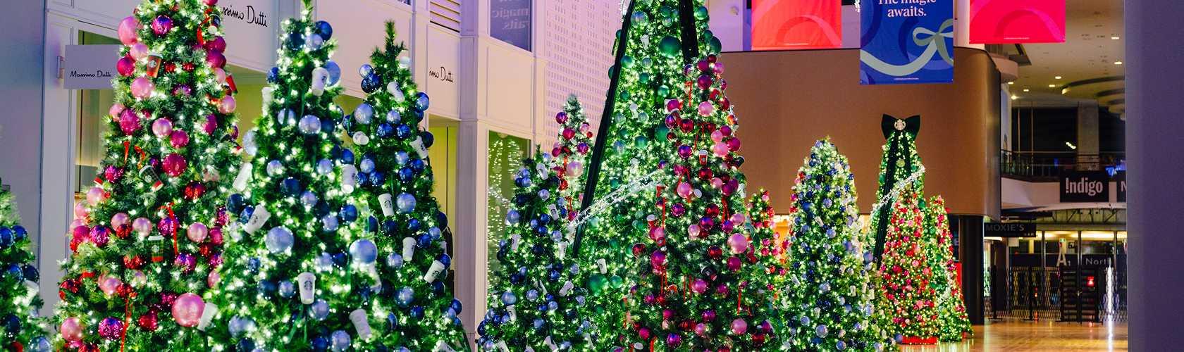 Multiple decorated Christmas trees illuminated in Yorkdale Shopping Centre
