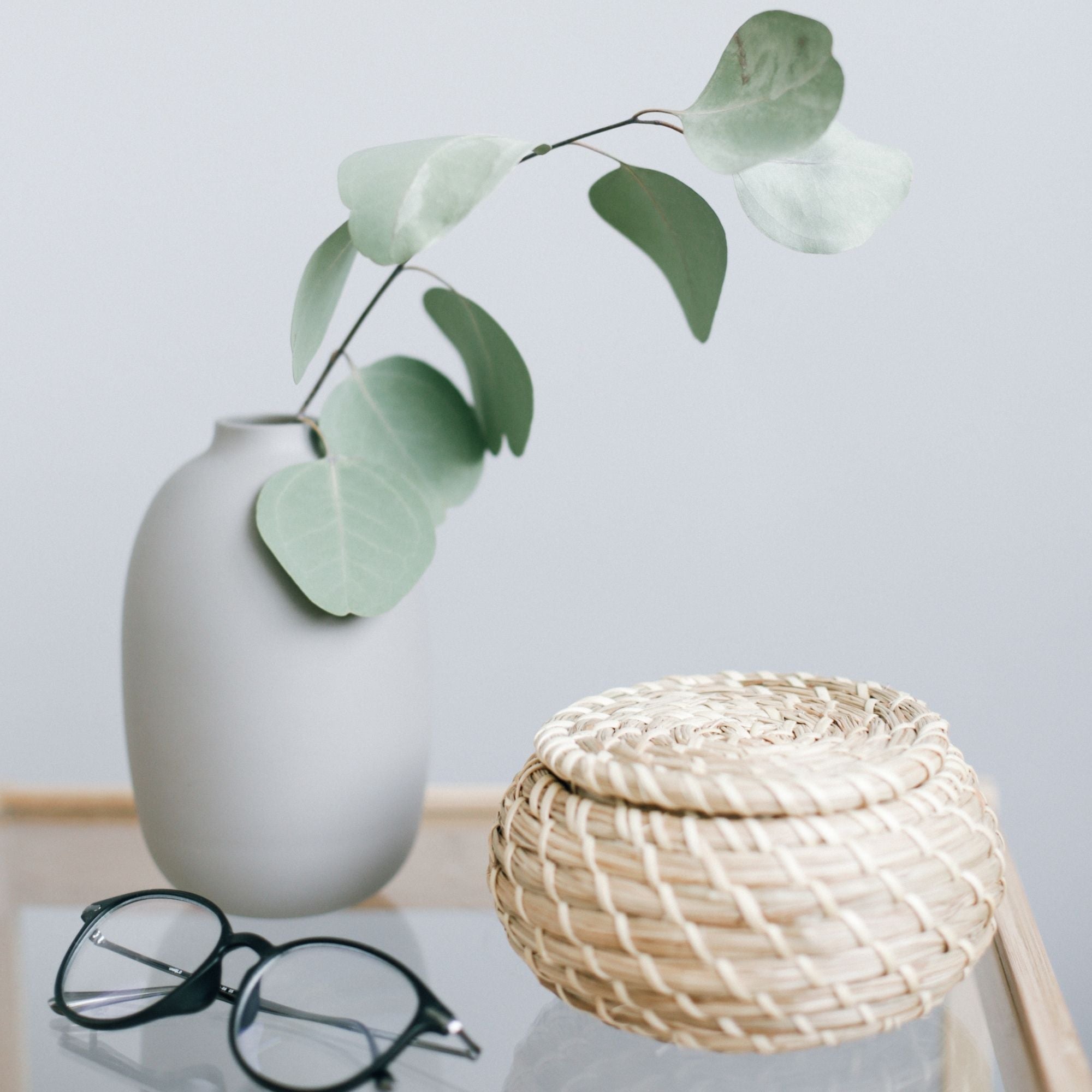 Glasses on table with brown wicker table and vase