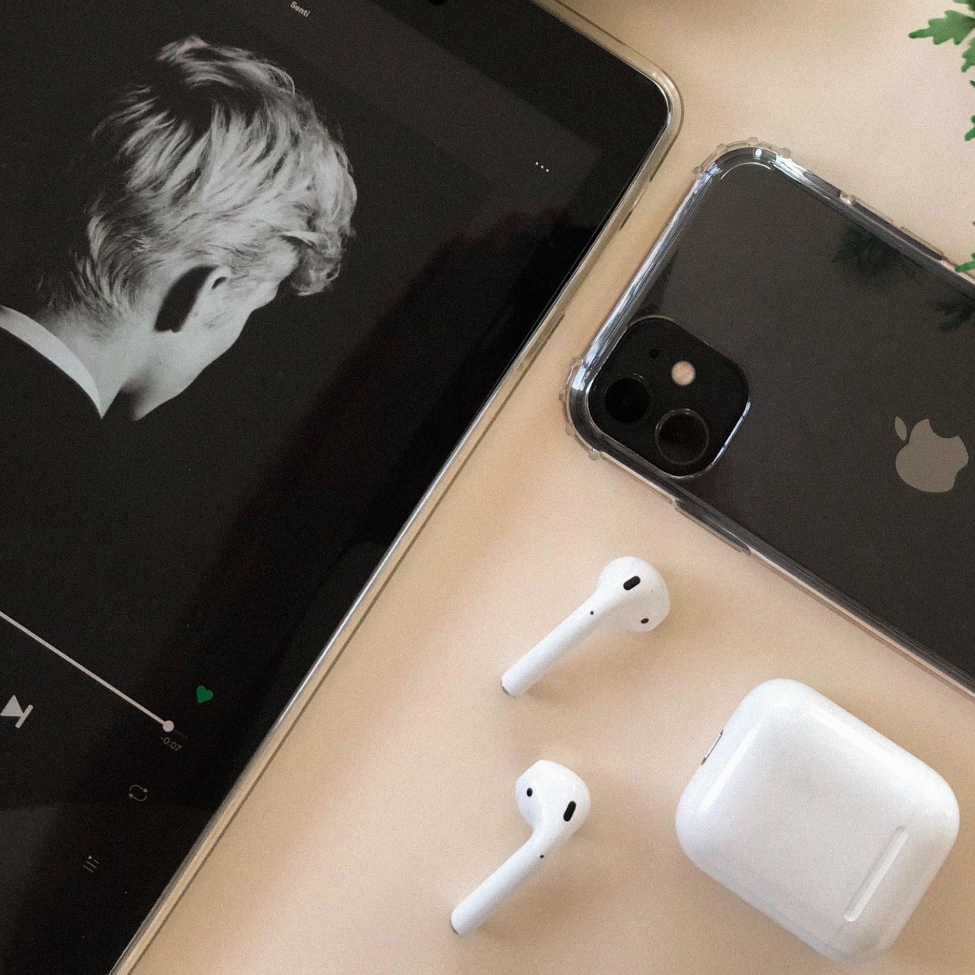 Apple products (airpods, iphone) stylized on table