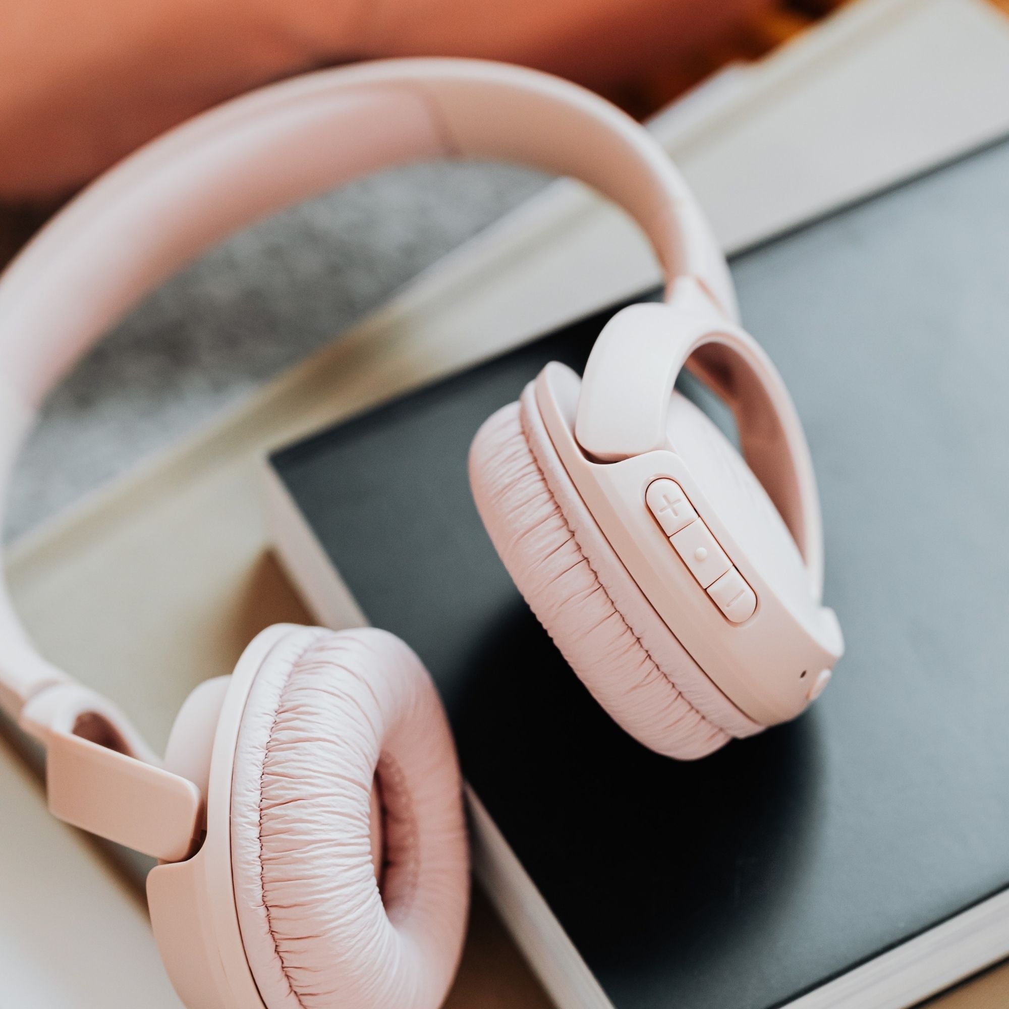 Pink headphones on notebook