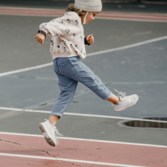 Young kid playing on outdoor basketball court