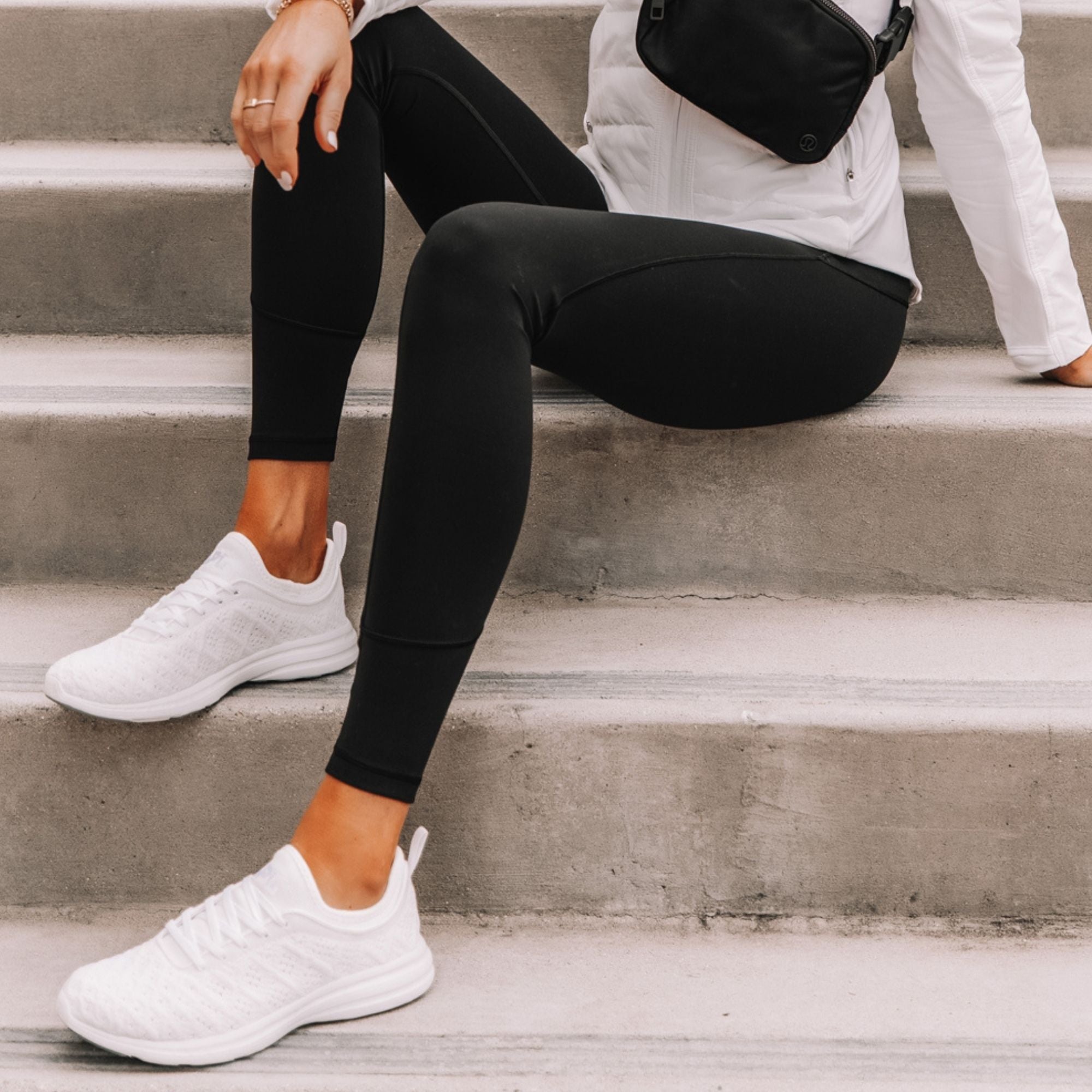 White sneakers with black leggings on woman