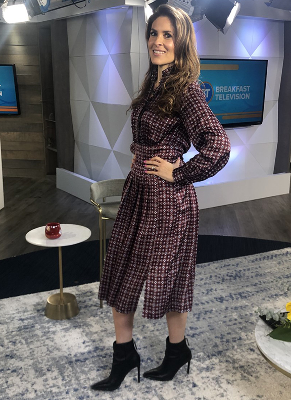 Dina wearing muted plaid dress with black pointy boots - 2