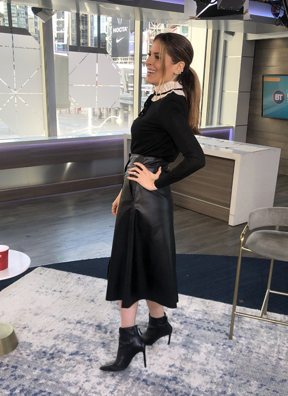 Dina wearing black leather skirt with pointy black booties