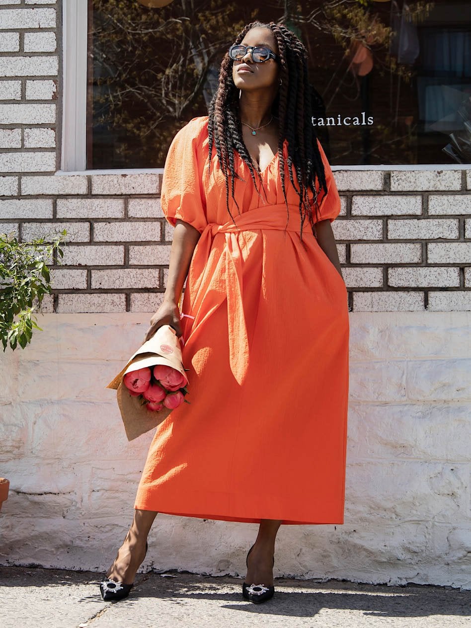 Model in orange dress