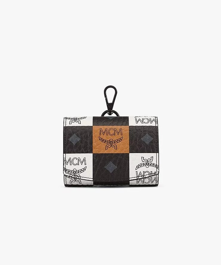 MCM branded dog poop bag dispenser in a black, white and tan checkered print. Each "check" has the MCM logo.
