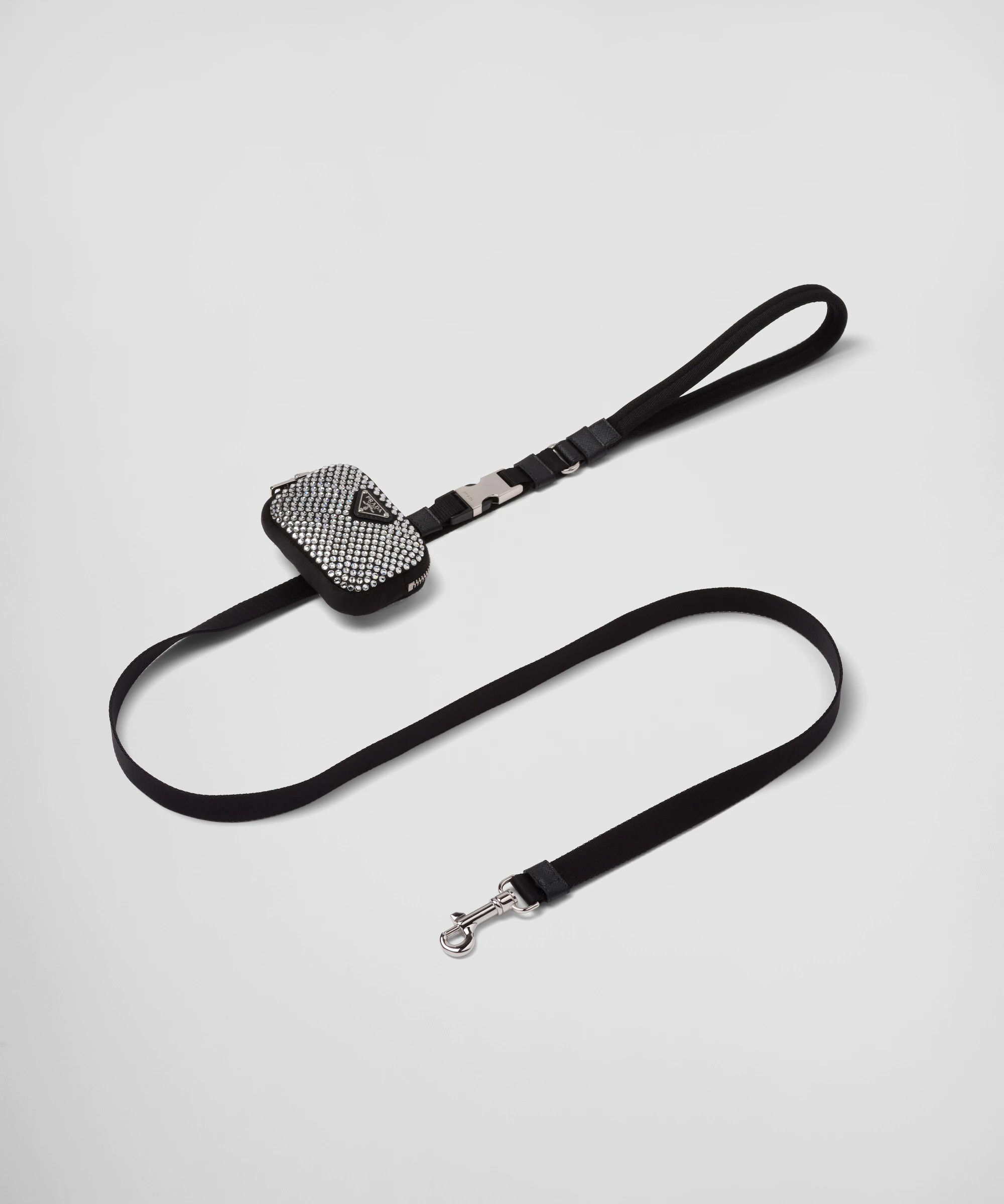 Black Prada pet leash with silver-tone hardware and a jewel-encrusted poop bag attached.