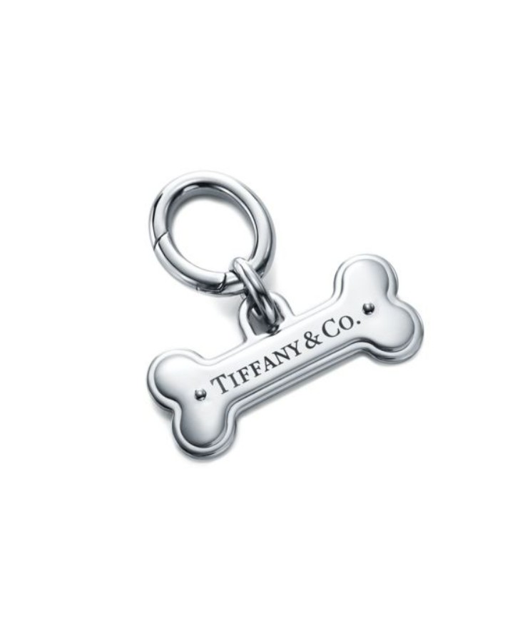 Tiffany & Co. pet tag in the shape of the bone, made of silver-tone metal and featuring engraved text that reads Tiffany & Co.