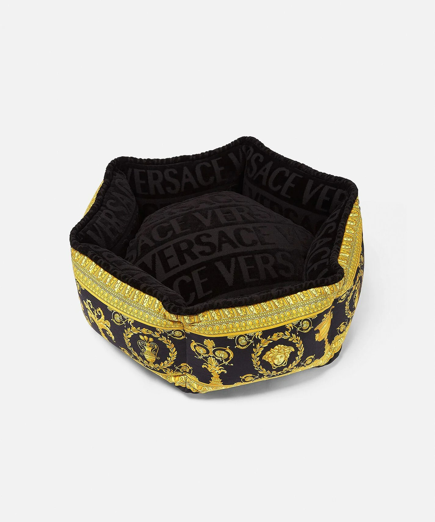 Versace dog bed in black and gold. The outer portion of the bed features the Versace logo print.