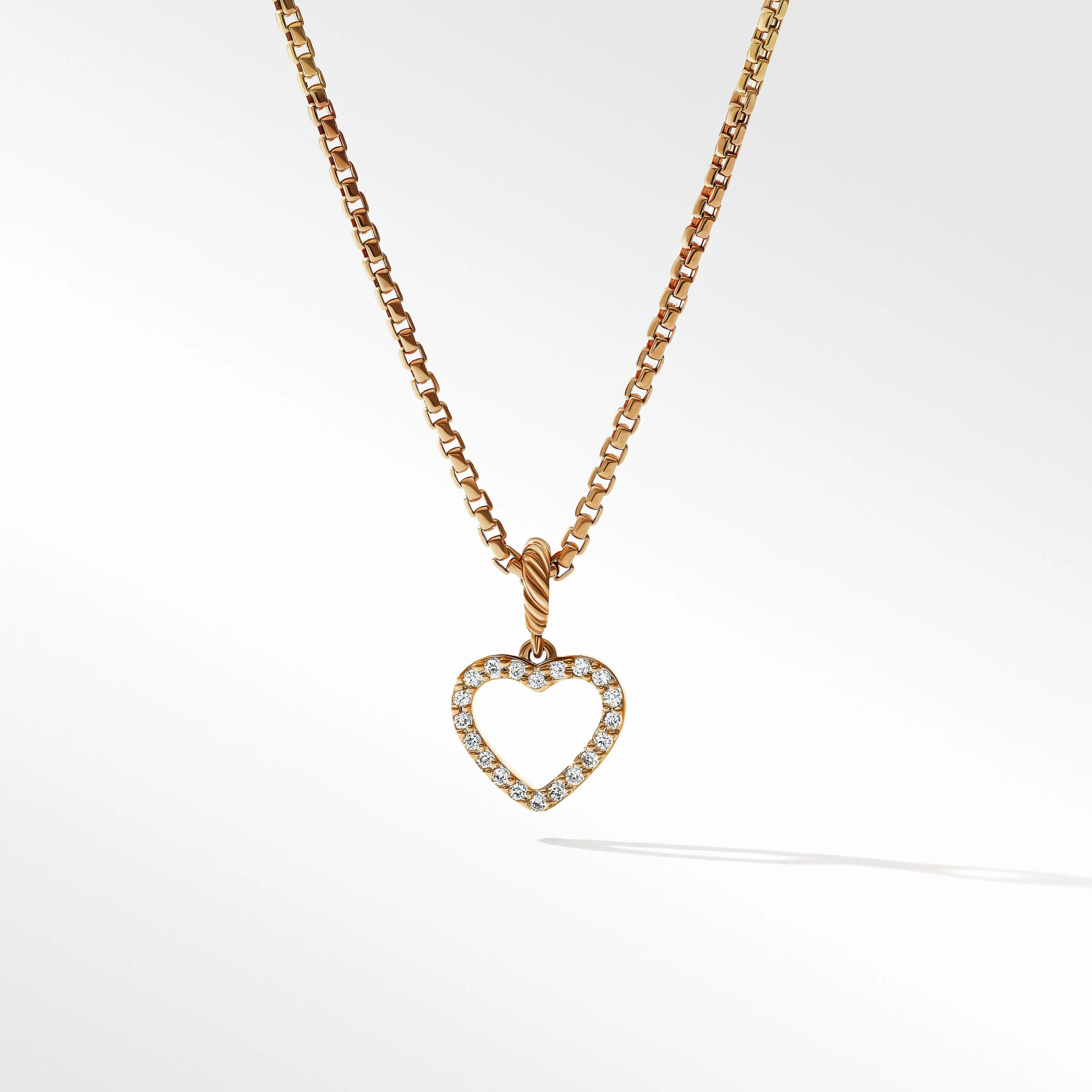 Gold David Yurman necklace with a diamond heart charm.