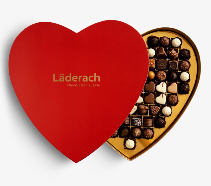 Product image of Laderach chocolates in a red, heart-shaped box.