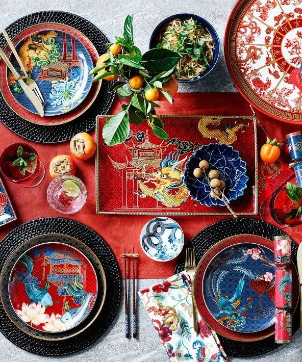 Flat-lay image of a table setting featuring dishware with Asian motifs.