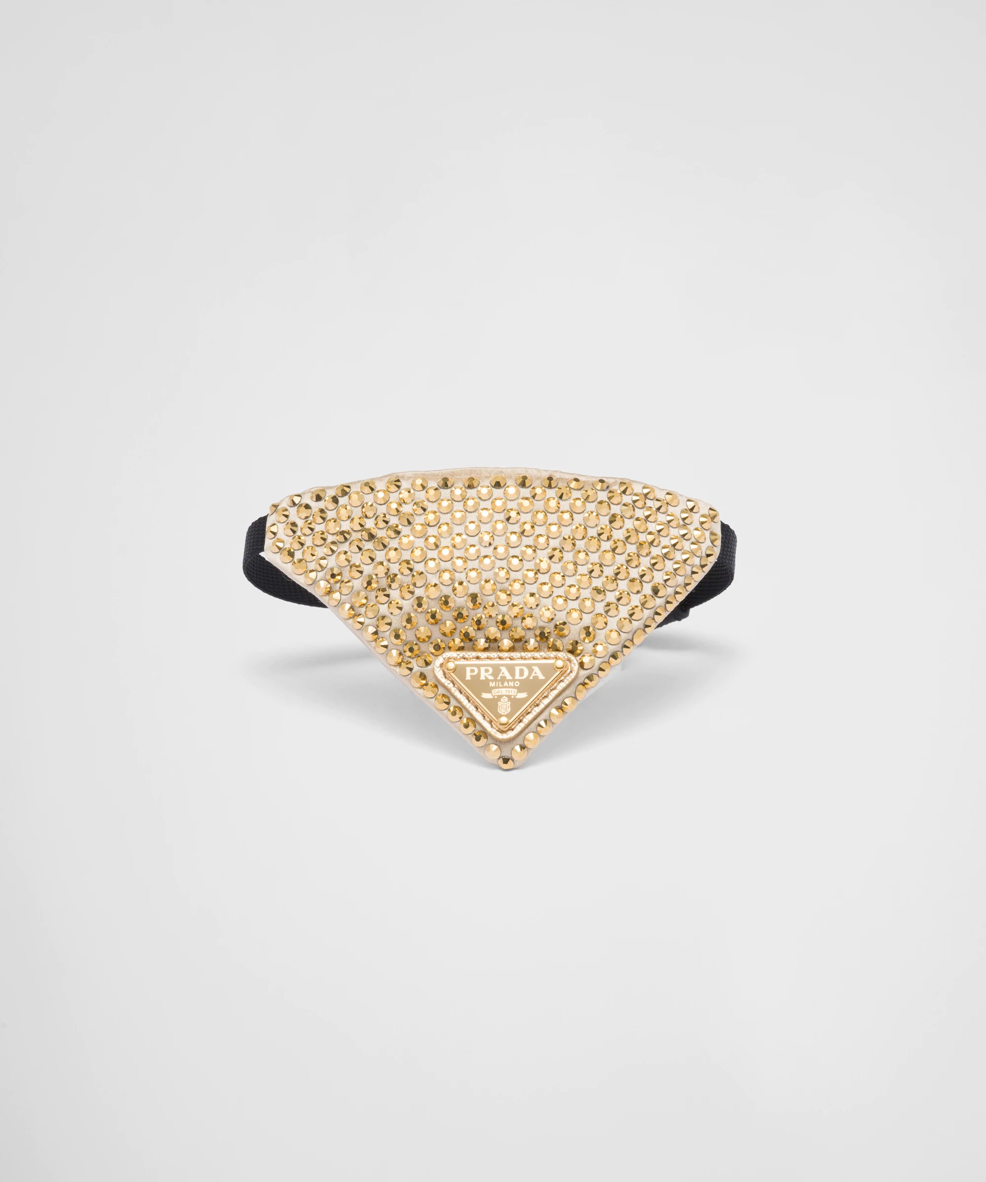 A gold crystal Prada pet bandana attached to a black collar.