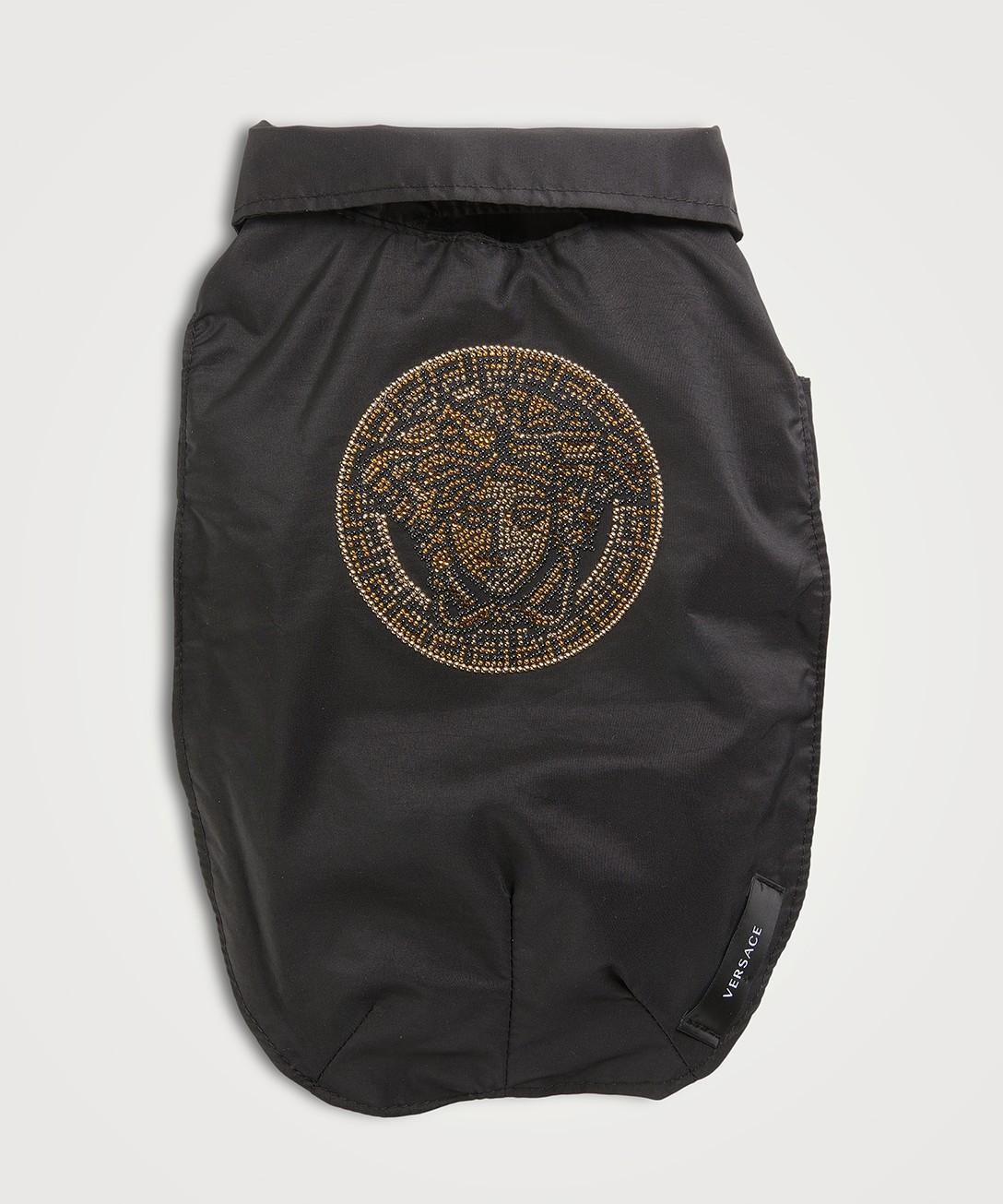 A black Versace dog coat with the Versace logo in gold on the back.