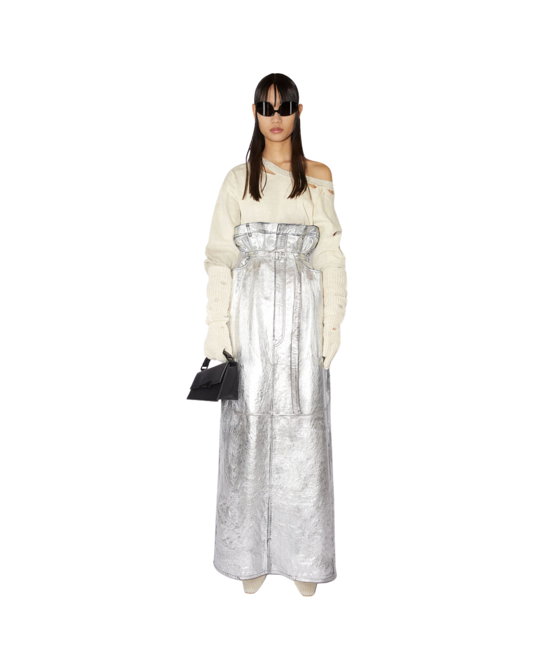 Image of a model on a white backdrop wearing the following Acne Studios items: A cream-coloured top exposing her left shoulder, long matching cream gloves and a very-high waisted silver leather skirt brushed in metallic. She wears dark sunglasses and holds a black bag.