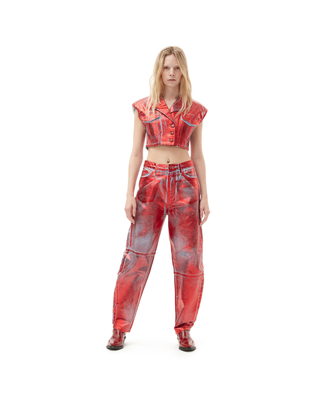 Image of a matching leather GANNI set featuring a cropped button up vest and oversized trousers spray painted in metallic red.