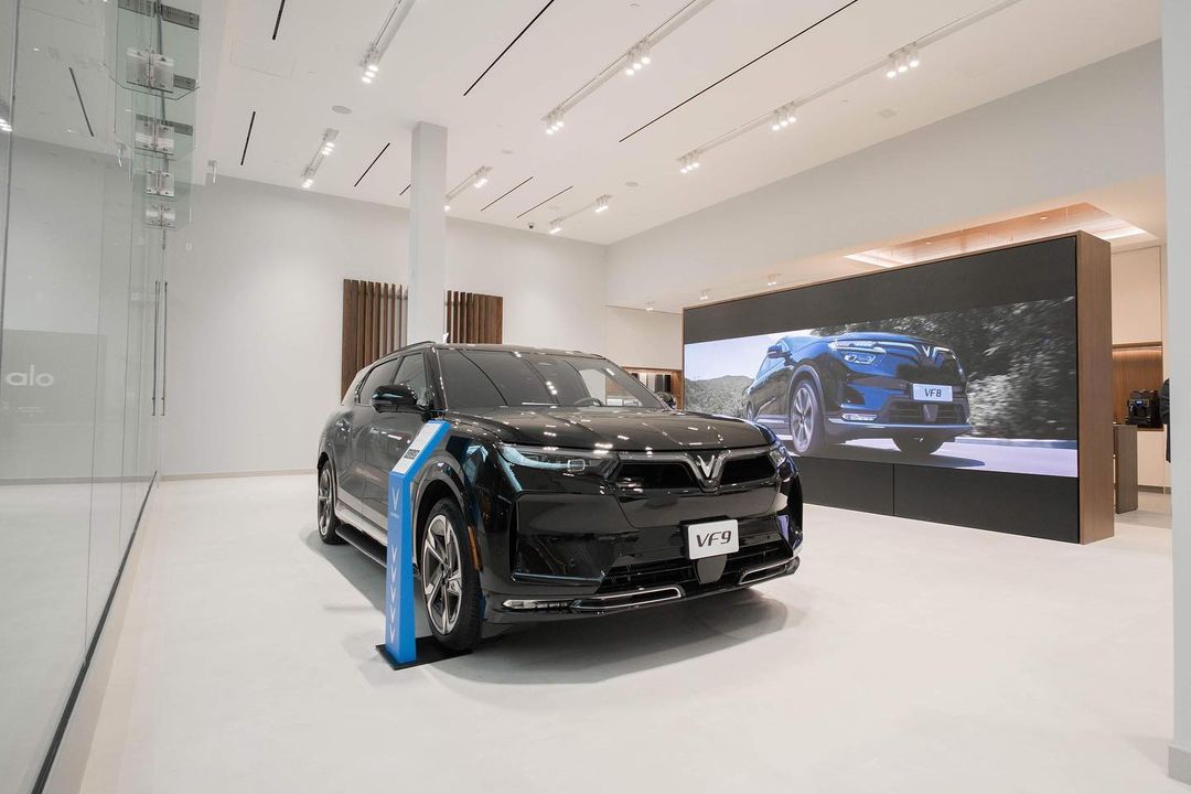 A black SUV from Vinfast Motors sitting in a showroom.