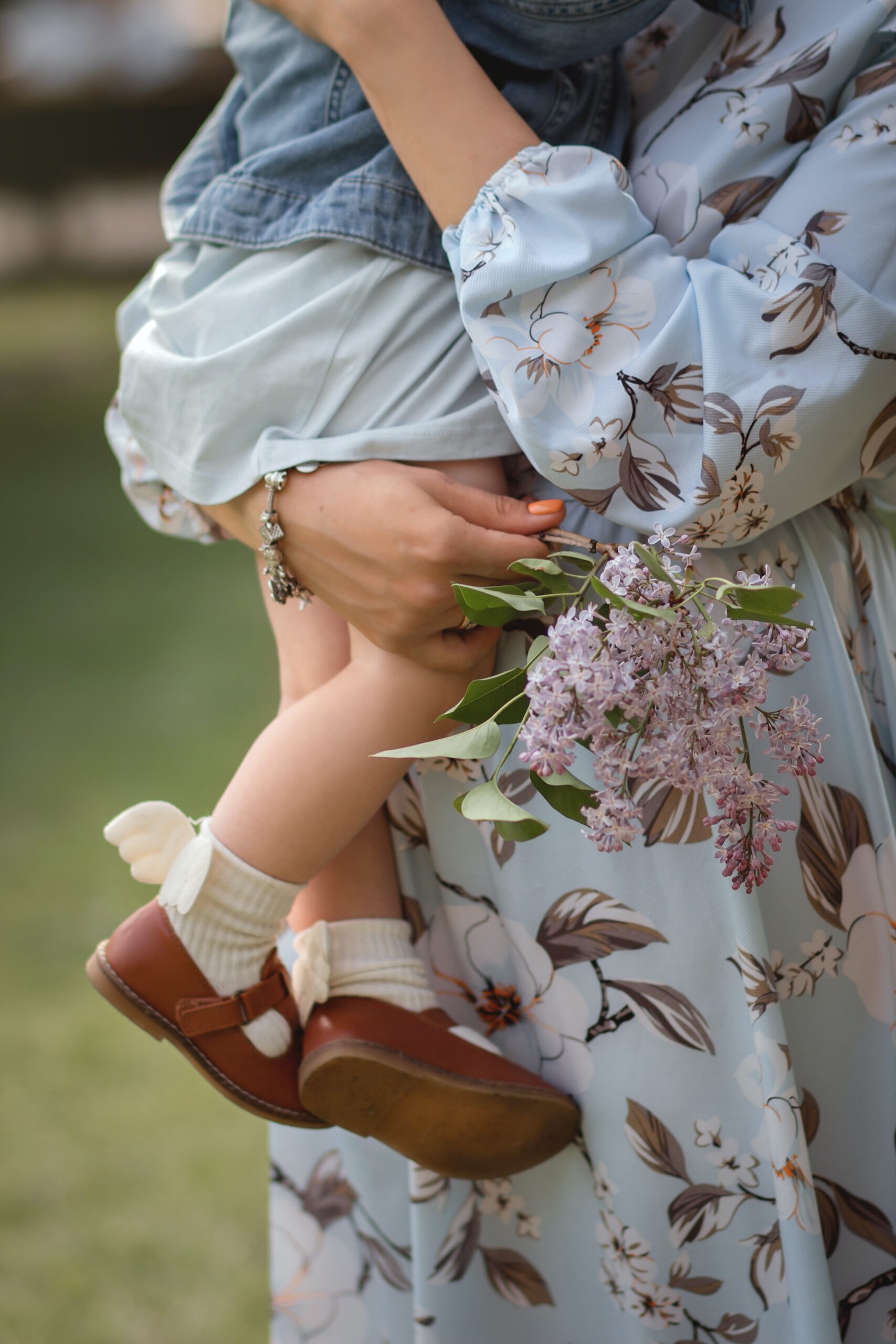 Woman in a floral dress holding a baby