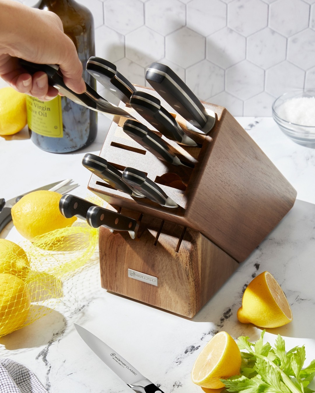 A hand reaching for a knife block