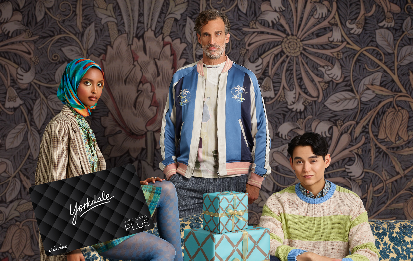 promotional image for a yorkdale gift card featuring three individuals posing against a printed backdrop