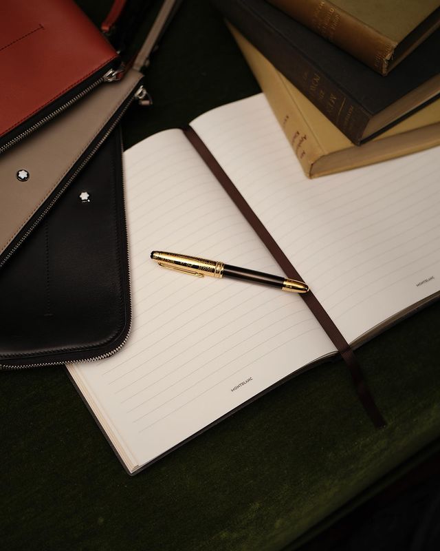 image of an open notebook with a fountain pen