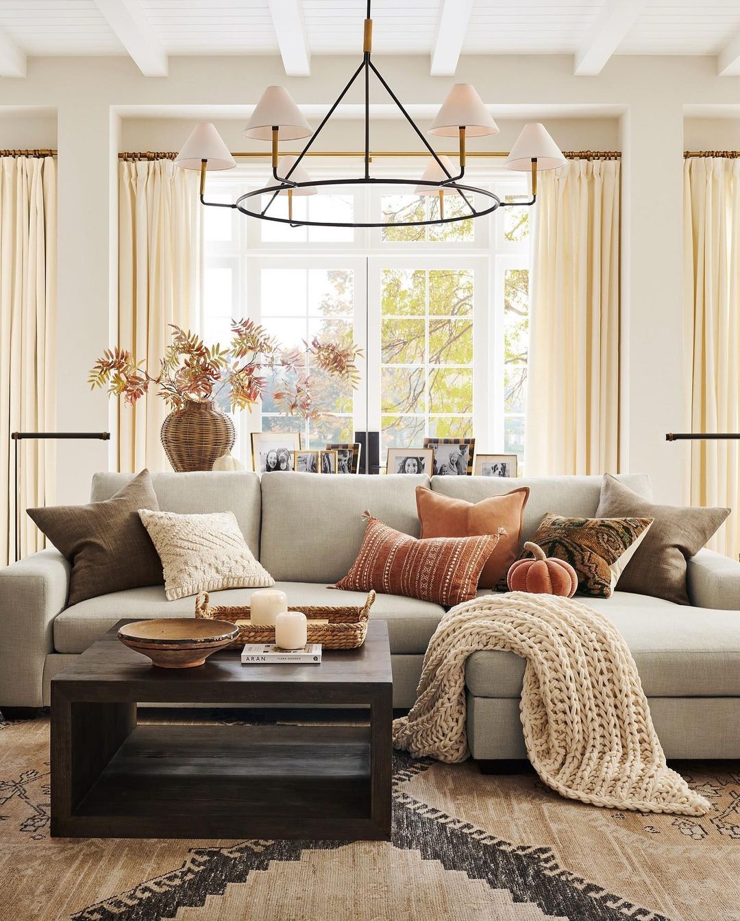 Pottery Barn; Thanksgiving; Festive staging; blankets and throws in a cozy living room; 2024