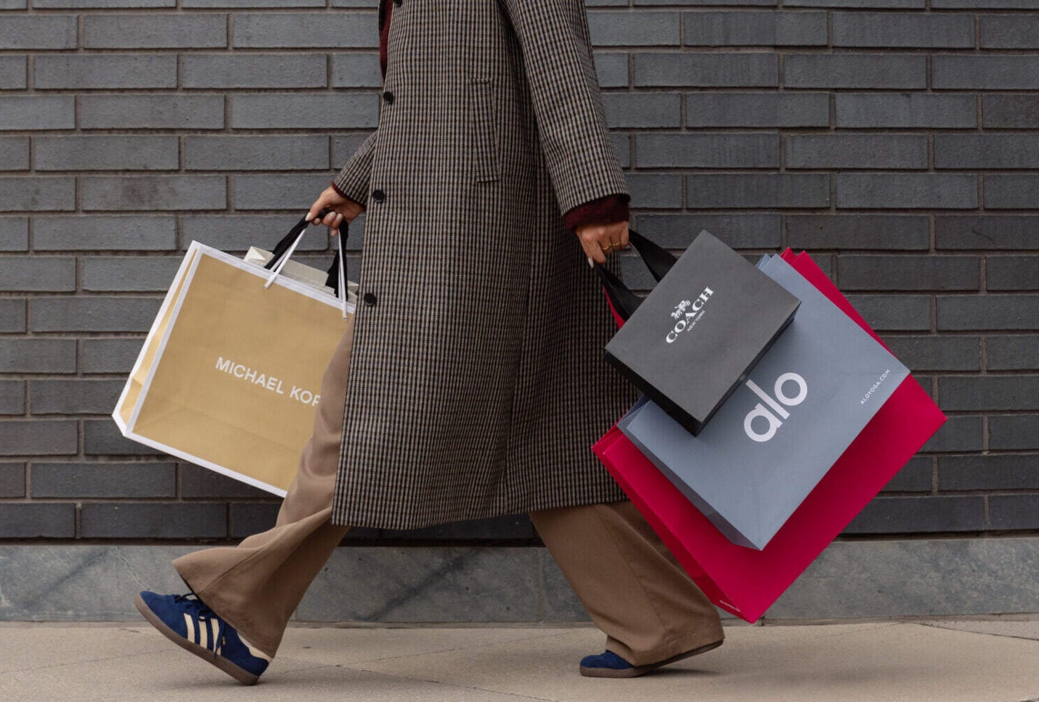 Woman with several shopping bags walking